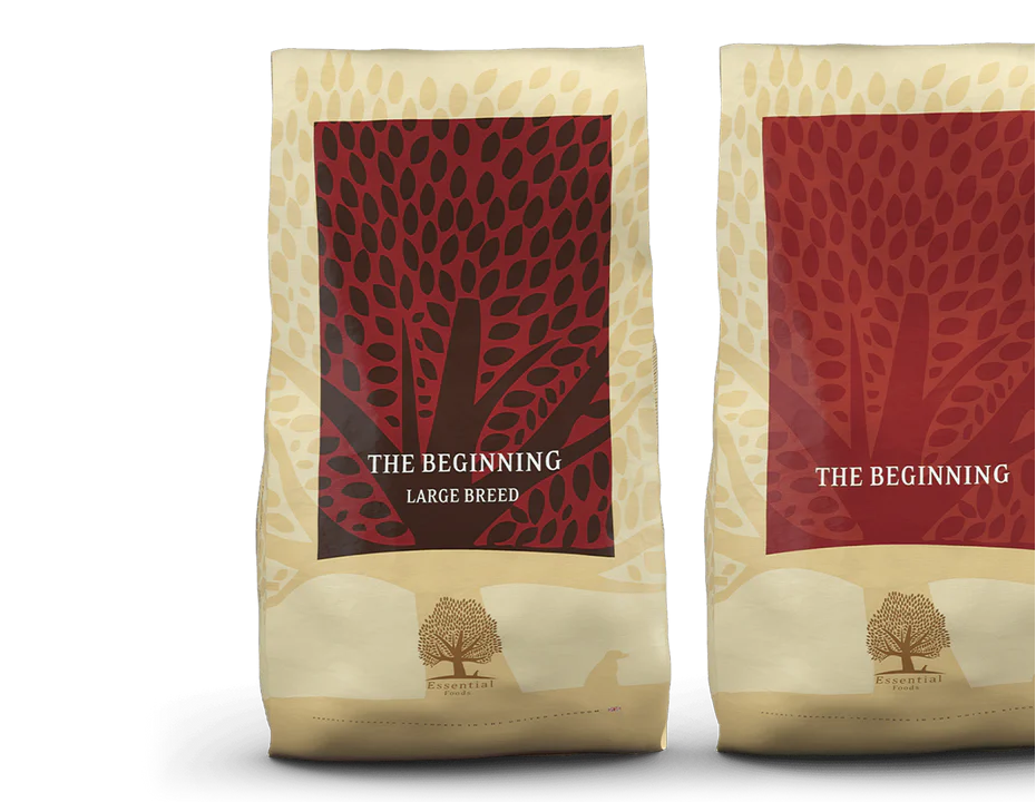 Two dog food bags with red and beige labels on a white background